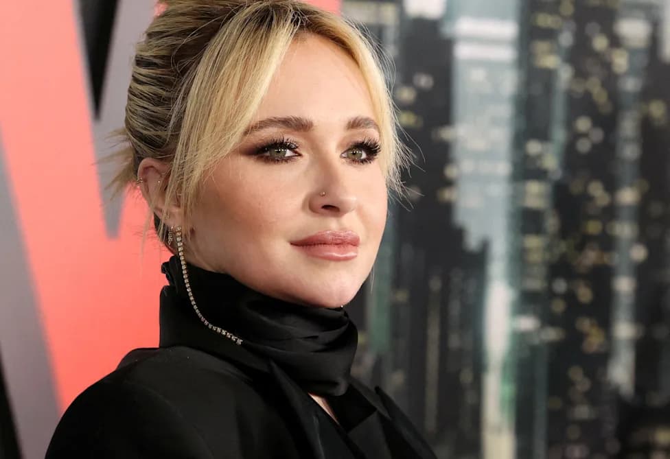 Hayden Panettiere at a red carpet event in a black turtleneck and scarf