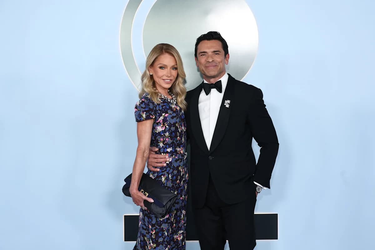 Kelly Ripa and Mark Consuelos posing together at a red carpet event