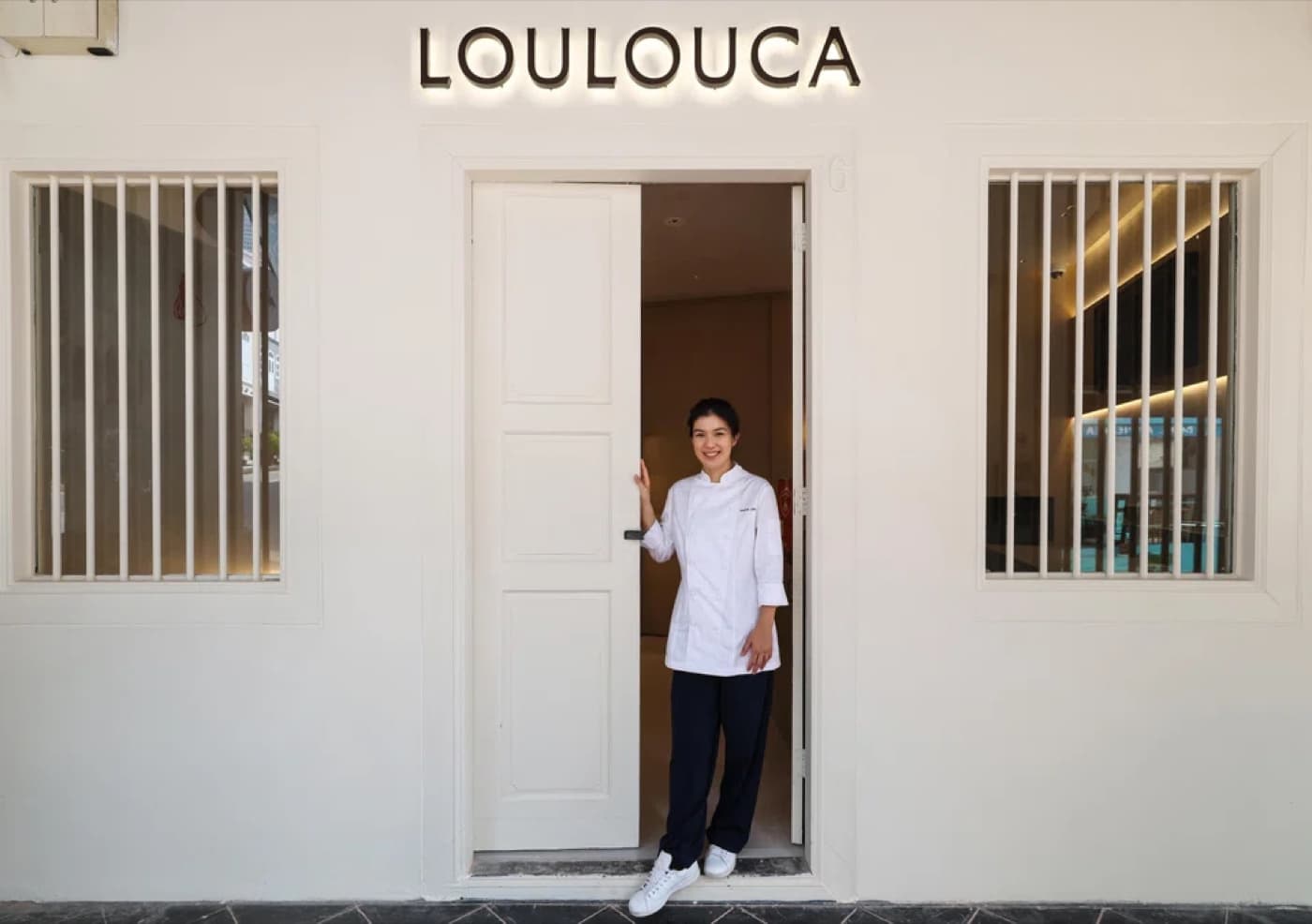 Chef Louisa Lim standing in the doorway of her restaurant Loulouca in Singapore