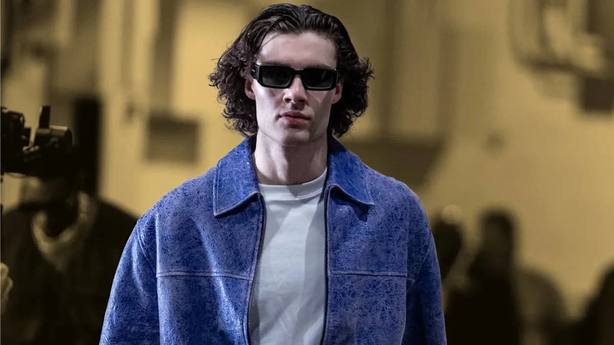 A runway look mixing an oversized textured jacket with a plain white tee, reflecting the streetwear influence now showing up in NBA tunnel fashion