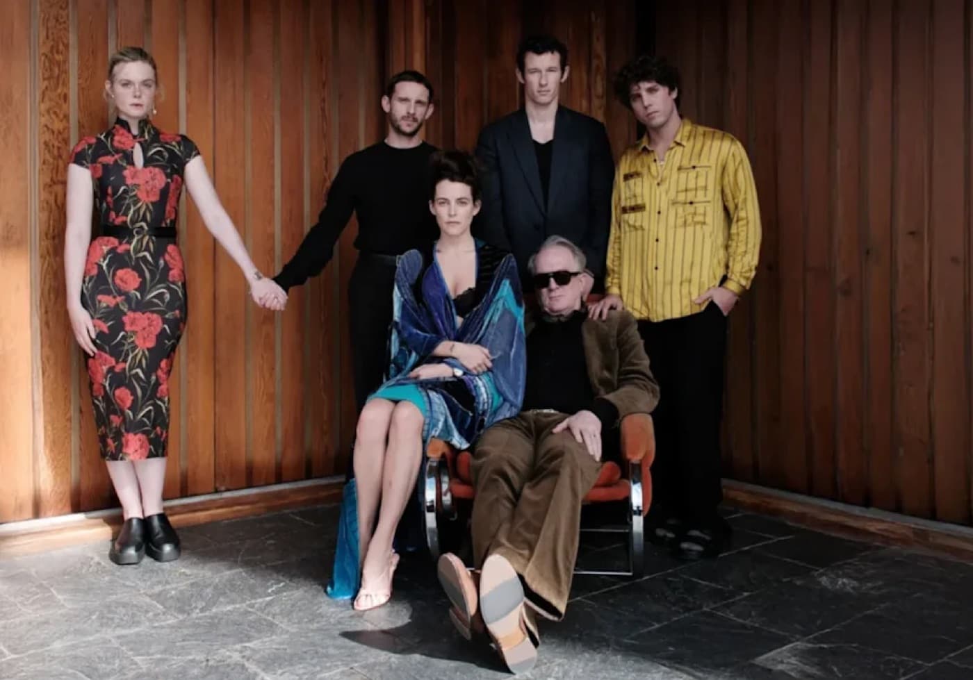The cast of Rosebush Pruning posed together against a wood paneled wall