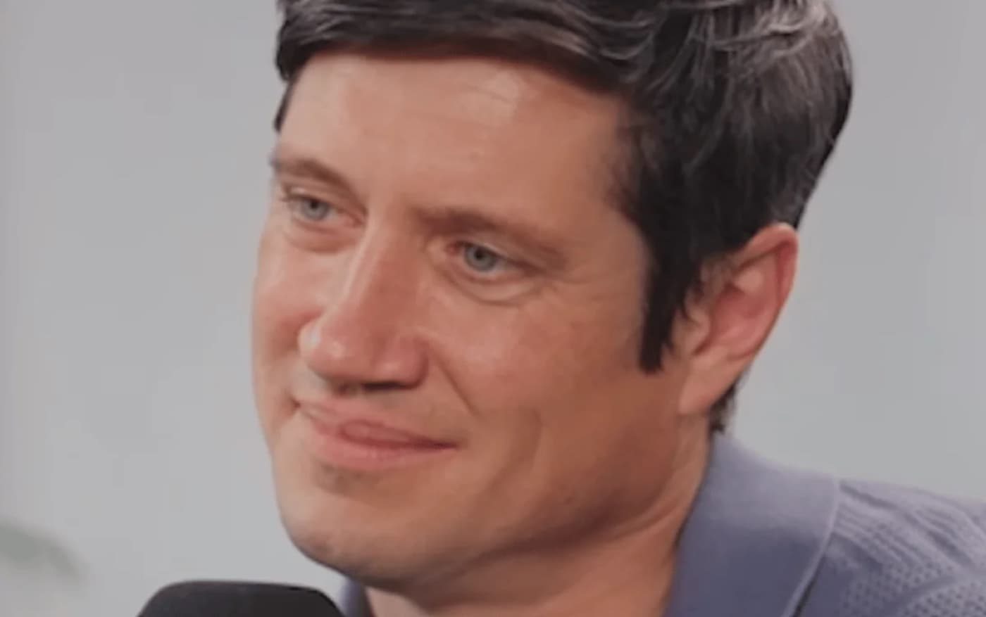 Vernon Kay smiling while speaking into a microphone during a radio interview
